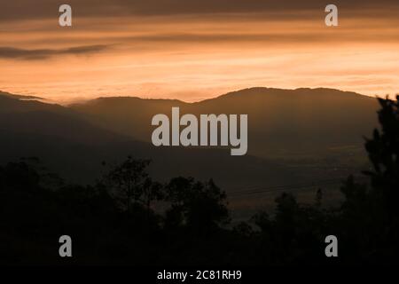Hohe Berge, die unter dem rosafarbenen Wolkenhimmel glänzen Stockfoto