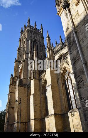 Blick nach oben auf die Westtürme von der Südseite des York Minster. Die Steinarbeiten Details sind zu sehen, die den gotischen Stil zeigen. York, Großbritannien Stockfoto