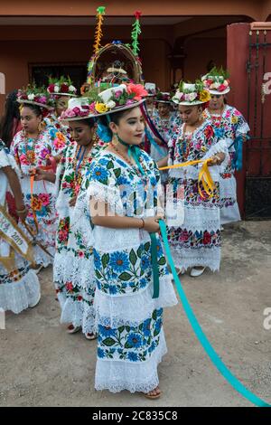Frauen in traditionellen festlichen gestickten Huipils und geblümten Hüten bereiten sich für den Tanz des Schweins Kopf und der Türkei, oder Baile de la cabeza del Stockfoto