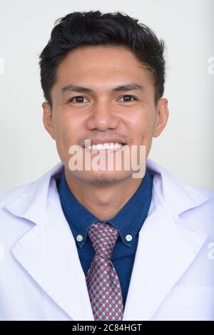 Portrait von glücklich gut aussehend asiatischen Mann Arzt lächelnd Stockfoto