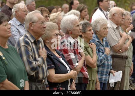 Pflugerville, Texas, USA, 11. November 2005: Zuschauer stehen bei der Einweihung des Fallen Warrior Memorial in einem Stadtpark auf dem Laufenden. Die Gedenkstätte ehrt die neun Soldaten, die vom Ersten Weltkrieg bis zur Gegenwart aus der kleinen Gemeinde im Zentrum von Texas außerhalb von Austin getötet wurden. ©Bob Daemmrich Stockfoto