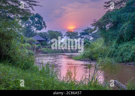 Sonnenaufgang Blick auf Ishasha Fluss, mit Bäumen wachsen und die Reflexionen auf dem Wasser, Queen Elizabeth Nationalpark, Ishasha, Uganda, Afrika Stockfoto