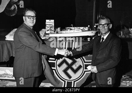 AJAXNETPHOTO. SEPTEMBER 1974. PORTSMOUTH, ENGLAND. - ERÖFFNUNGSSITZUNG - (L-R) HERR GORDON STEVENS VON DUNCAN ROAD, PORTSMOUTH, UND HERR HAROLD PRINGLE VON MANCHESTER BEI DER ERÖFFNUNGSSITZUNG DER COASTAL FORCES VETERANS ASSOCIATION IM VICTORY CLUB, HMS NELSON. HINTERGRUND IST DIE DEUTSCHE KRIEGSMARINE-KRIEGSFLAGGE, DIE PRINGLE ALS SOUVENIR MITBRACHTE, ALS DIE DEUTSCHE BOOTSFLOTTE IM MAI 1945 IN ANCONA (ITALIEN) KAPITULIERTE. HERR PRINGLE WAR BEI DER 59. MTB-FLOTTILLE. FOTO: JONATHAN EASTLAND/AJAX REF:7527 7 Stockfoto