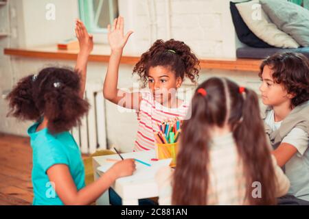 Kinder, die während des Kunstunters die Hände erheben Stockfoto