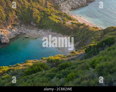 Korfu, Griechenland, Porto Timoni. Blick auf den berühmtesten Doppelstrand und die Bucht von Afionas vom Aussichtspunkt auf dem Weg. Sonnenuntergang goldenes Stundenlicht Stockfoto