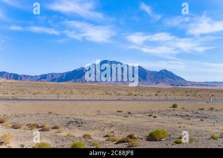 Lange Autobahn auf gobi Wüste, Straße hat Sand weht mit Wildnis Hintergrund in Qingha.China Stockfoto