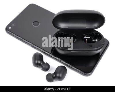 Kabelloser Kopfhörer mit Tasche und Smartphone auf weißem Hintergrund Stockfoto