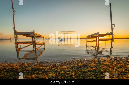 Sonnenuntergang auf einem Teich mit Muschelzuchtplätzen. Stockfoto