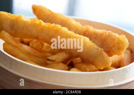 Nahaufnahme von Fisch und gebratenen Kartoffeln in legeren Holzkorb präsentiert Stockfoto