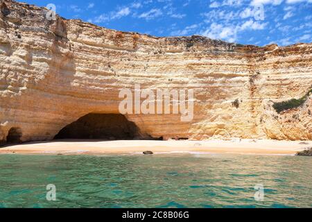 Blick auf die Klippen und Höhlen von Benagil von der Meerseite. Wunderschöne Naturgrotten mit smaragdgrünem Wasser und kleinen Stränden im Atlantik Stockfoto