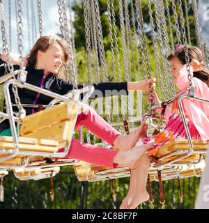 Kinder genießen die Fahrt auf einem Karussell an einem sonnigen Nachmittag im Heritage Park in Calgary, Alberta Stockfoto