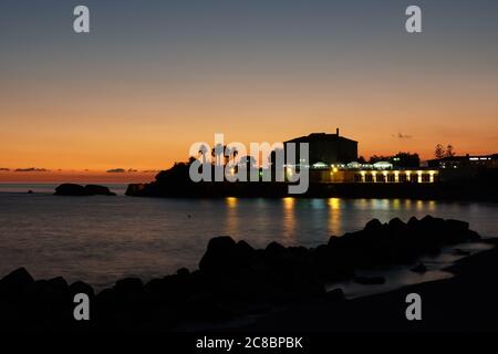 Eine wunderschöne Landschaft des Sonnenuntergangs, der sich im Meer in Belvedere Marittimo, Cosenza, Italien, spiegelt Stockfoto