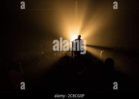 Mann spielt Gitarre auf einer Bühne, Silhouette Stockfoto