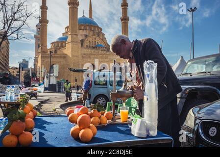 Man verkauft frisch gepressten Saft neben dem Martyrs Square in der Innenstadt von Beirut, Libanon - Mohammad Al-Amin sunnitisch muslimische Moschee auf Hintergrund Stockfoto