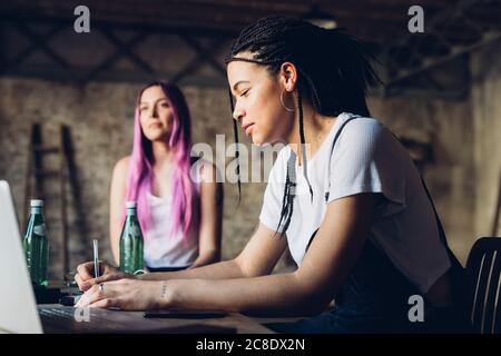Zwei kreative Frauen arbeiten im Loft-Büro Stockfoto