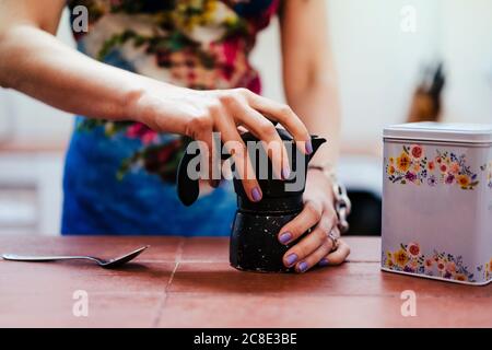 Nahaufnahme der Hände der Frau mit Kaffeekanne in der Küche Stockfoto