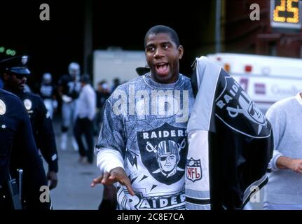 Magic Johnson in Raders Ausrüstung Teilnahme an einem L.A> Raiders Spiel im Coliseum in Los Angeles,1984 Stockfoto