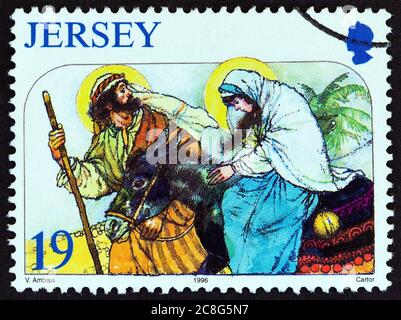 JERSEY - UM 1996: Eine in Großbritannien gedruckte Briefmarke aus der Weihnachts-Ausgabe zeigt die Reise nach Bethlehem, um 1996. Stockfoto