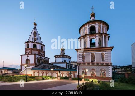 Russland, Irkutsk - 30. Juni 2020: Die Kathedrale der Erscheinung des Herrn. Orthodoxe Kirche, katholische Kirche in Sonnenuntergang mit Pflastersteinen Stockfoto