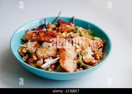 Gesundes vegetarisches Abendessen oder Mittagessen. Salat mit karamellisierten gegrillten Birnen, Walnüssen, Blauschimmelkäse und Granatapfelkernen. Stockfoto