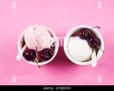 Zwei Eisbecher mit Kirschen auf rosa Stockfoto