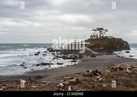 Wolkiger Nachmittag in Crescent City California mit einem wunderschönen Blick auf den Battery Point Leuchtturm und das Meer bei Ebbe Stockfoto