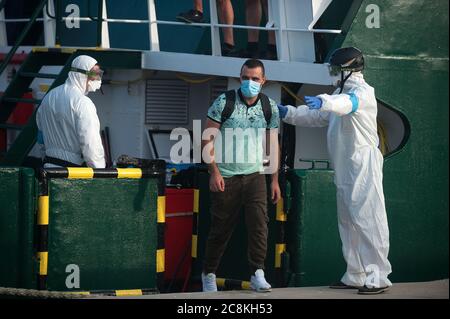 Mitglieder der Europäischen Grenz- und Küstenschutzbehörde (Frontex) helfen einem Migranten, von einem Patrouillenschiff im Hafen von Malaga auszusteigen, nachdem es von den spanischen Guardians auf dem Mittelmeer abgefangen wurde.EIN spanisches Zivilschutzschiff fing etwa 82 algerische Migranten in der Nähe der Küste von Almeria ab, während es versuchte, Europa zu erreichen Mit kleinen Booten. Während der Coronavirus-Pandemie hat die Schließung der marokkanischen Grenze zu Spanien als Maßnahme zur Verhinderung der Ausbreitung der Coronavirus-Krankheit einen drastischen Rückgang der Zahl der Migranten verursacht, die versuchen, die spanische Küste über Alboran Sea Route zu erreichen, während t Stockfoto