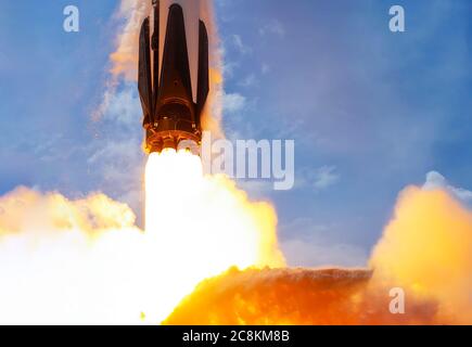 Raketenstart gegen blauen Himmel aus nächster Nähe. Elemente dieses Bildes wurden von der NASA eingerichtet. Stockfoto
