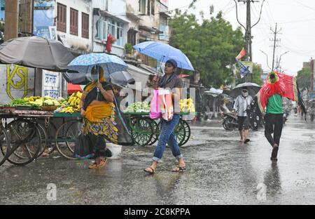 Beawar, Rajasthan, Indien, 24. Juli 2020: Fußgänger gehen bei starkem Regen auf einer Straße in Beawar. Kredit: Sumit Saraswat/Alamy Live Nachrichten Stockfoto