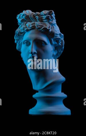 Statue einer Büste von Apollos Kopf in blau lokal Licht auf blauschwarzem Hintergrund Stockfoto