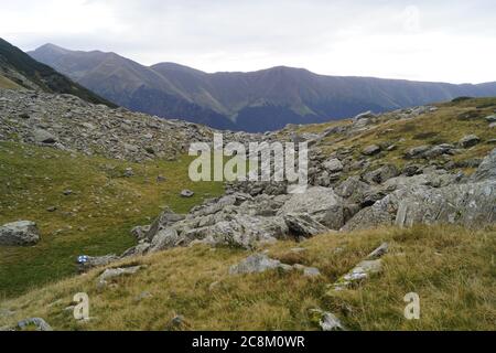 Wandermarkierung auf dem Felsen mit Panoramablick auf die Berge Stockfoto