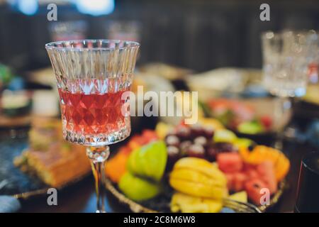 Konzentrieren Sie sich auf Hände Servieren Gerichte mit Fleisch und Gemüse an eine Gruppe von Freunden um einen Tisch auf einer Sommerterrasse versammelt. Stockfoto