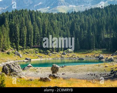 Der Karersee unterhalb des Karerpasses am Fuße des Latemarmassivs in Südtirol, Italien Stockfoto