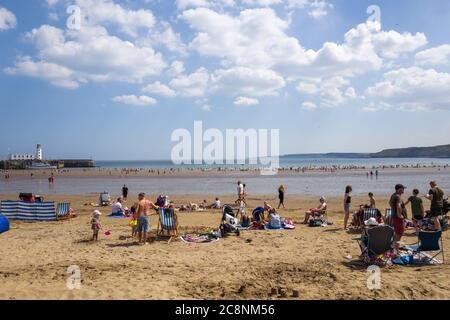 Besucher an einem schönen Sommertag am Scarborough Beach, North Yorkshire, Großbritannien. Ideal für einen Aufenthalt. Stockfoto