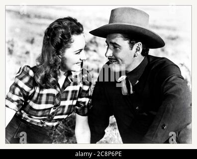 ***DATEI FOTO*** Schauspielerin Olivia de Havilland ist am 104. Gestorben. 1939 amerikanischer Western-Film unter der Regie von Michael Curtiz mit Errol Flynn, Olivia de Havilland und Ann Sheridan. Der Film basiert auf einer Geschichte von Robert Buckner und handelt von einem texanischen Viehmakler, der die brutale Gesetzlosigkeit von Dodge City, Kansas, erlebt und den Sheriff zum Säubern der Stadt nimmt. Der Film Dodge City wurde im frühen Technicolor gedreht und war einer der erfolgreichsten Filme des Jahres. Dies war der 7. Von 11 Filmen, in denen de Havilland und Flynn zusammen auftraten. Kredit: Hollywood Fotoarchiv/MediaPunch Stockfoto