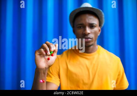 Mann mit Kegeln stehen vor blauem Hintergrund, schwarz lebt Materie Konzept. Stockfoto