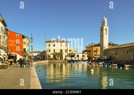 Die Altstadt am Ufer des Gardasees mit Spaziergängen, das Rathaus und die Kirche St. Nicolò mit Blick auf den kleinen Hafen, Lazise, Italien Stockfoto