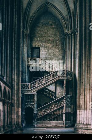 Atemberaubende spätgotische Bibliothekstreppe in der Kathedrale von Rouen (Rouen, Normandie - Frankreich) unter einer extravaganten gotischen Bogentür Stockfoto