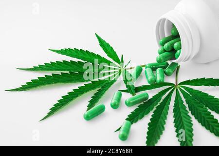 Cannabis, Marihuana Blätter und Medikamente Pillen isoliert auf weiß Stockfoto