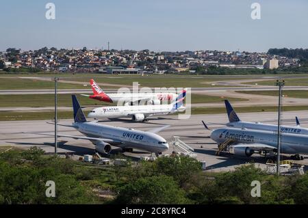 Blick von Morrinho auf die Position des Bodenverkehrs von Guarulhos Intl. Während zwei Flugzeuge direkt vor dem abgelegenen Flugzeugbereich besteuern. Stockfoto