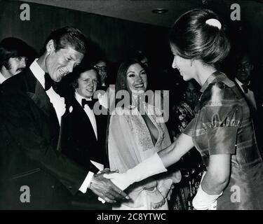 Jul. 5, 1973 - London, England, Vereinigtes Königreich - PRINZESSIN ANNE, rechts, begrüßt ROGER MOORE bei der Königlichen Premiere von "Live and Let die" am Odeon Theatre Leicester Square. Moore und JANE SEYMOUR, Mitte, sind die Stars des neuen Films. Seymour's Ehemann, MICHAEL ATTENBOROUGH, ist links von Seymour zu sehen. (Bild: © Keystone Press Agency/Keystone USA via ZUMAPRESS.com) Stockfoto