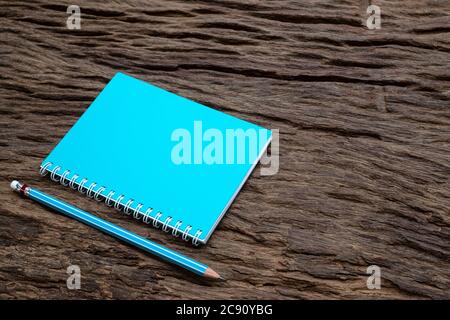 Bleistift und Buchmockup auf dem alten Holzschreibtisch im Hintergrund, Flachlay Foto, Draufsicht Stockfoto