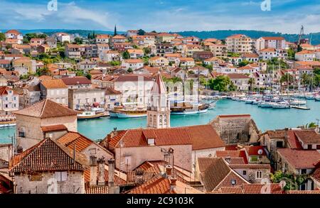 Ein Blick aus dem hohen Winkel auf die mittelalterliche Altstadt von Trogir, Kroatien im Vordergrund, und seine neueren Gebäude über das Wasser auf dem Festland. Stockfoto