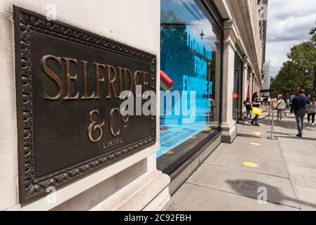 London, Großbritannien. 28. Juli 2020. Beschilderung vor Selfridges' Flagship-Store in der Oxford Street. Selfridges hat angekündigt, dass die Mitarbeiterzahl um 450 (14% der gesamten Mitarbeiterzahl) reduziert wird, da der Jahresumsatz deutlich unter dem Vorjahr liegen wird. Die Coronavirus-Pandemie und der allgemeine Rückgang im Einzelhandel werden als Hauptgründe für den Stellenabbau angeführt. Kredit: Stephen Chung / Alamy Live Nachrichten Stockfoto