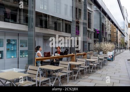 Zwei Frauen sitzen in EINEM Café in der Watling Street, London, England. Stockfoto