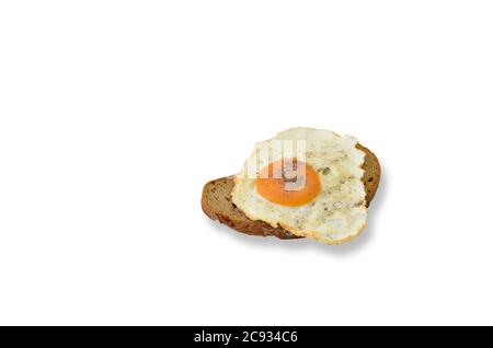 Spiegelei mit Salz und Pfeffer auf einer Scheibe Brot, Nahaufnahme, isoliert auf weißem Hintergrund Stockfoto