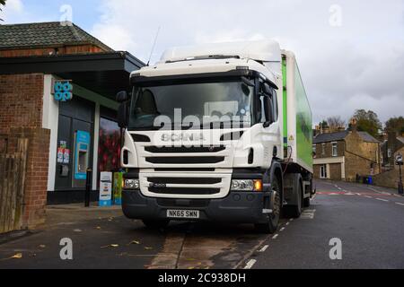 Coop Food Scania LKW ziehen einen gekühlten Anhänger machen ein Lieferung an ein Co-Op-Geschäft in einem Vorort Stockfoto
