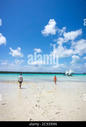 Zwei Personen, zu Fuß am Strand in der berühmten UPI Bucht, Pines Island, neukaledonien: Türkisfarbene Lagune, typische Felsen, blauer Himmel Stockfoto