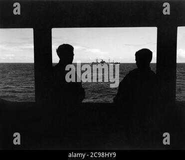 AKA-86 U.S.S. Woodford für den Marianas in Attack Cargo Konvoi OKS-14, Juli 1945. Zum 75. Jahrestag des V-J Day hat die Consoli Collection vier Fotoessays von U.S. Navy LT. (j.g.) veröffentlicht. Joseph J. Consoli. Die Fotos wurden zwischen Juli und Dezember 1945 auf den Marianen aufgenommen. Sie dokumentieren das Leben der US-Marine vor und nach der japanischen Kapitulation. Stockfoto