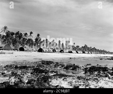 Quarset Hütten am Strand. Camp Dealey Submarine Recuperation Camp. Guam, Juli 1945. Zum 75. Jahrestag des V-J Day hat die Consoli Collection vier Fotoessays von U.S. Navy LT. (j.g.) veröffentlicht. Joseph J. Consoli. Die Fotos wurden zwischen Juli und Dezember 1945 auf den Marianen aufgenommen. Sie dokumentieren das Leben der US-Marine vor und nach der japanischen Kapitulation. Stockfoto